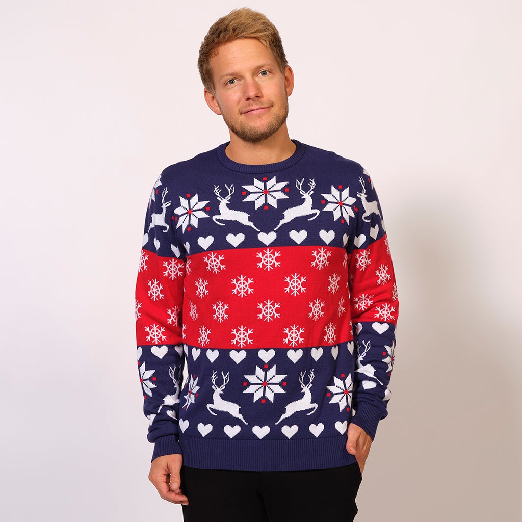En man i röd och blå jultröja med snöflingor och renar.